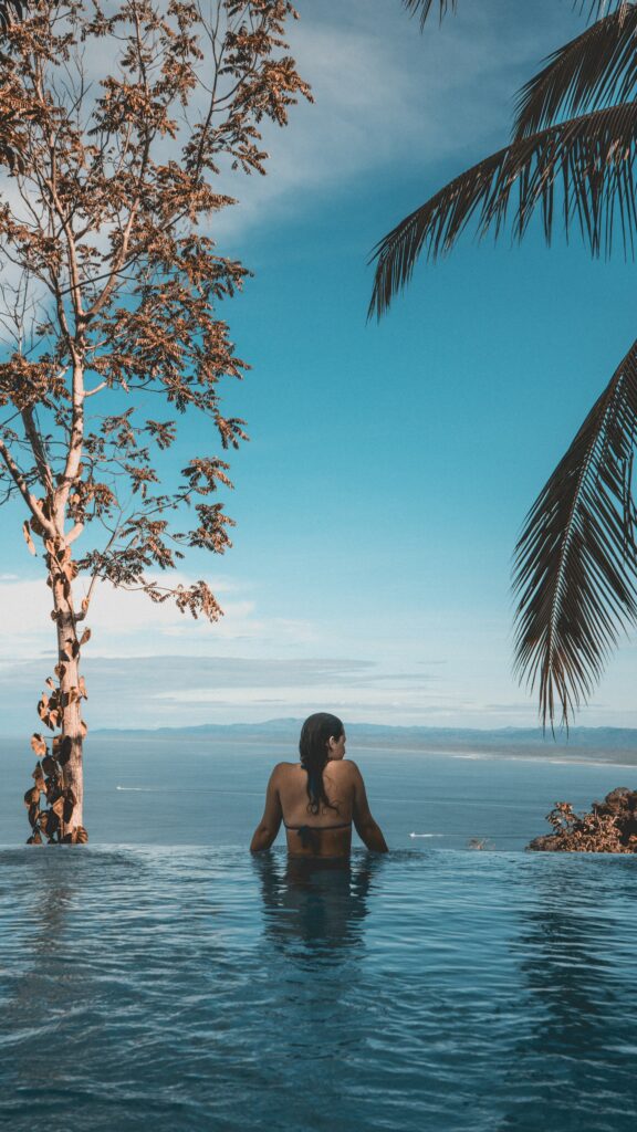 Longevity Clinic - woman in infinity pool overlooking mountain